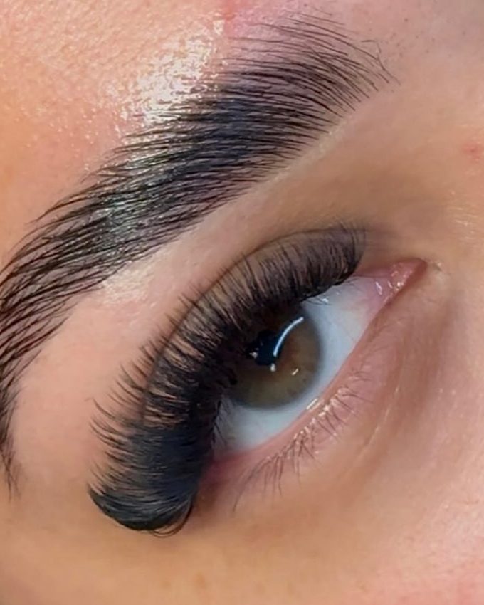 Close-up of laminated brow and wispy lash extensions